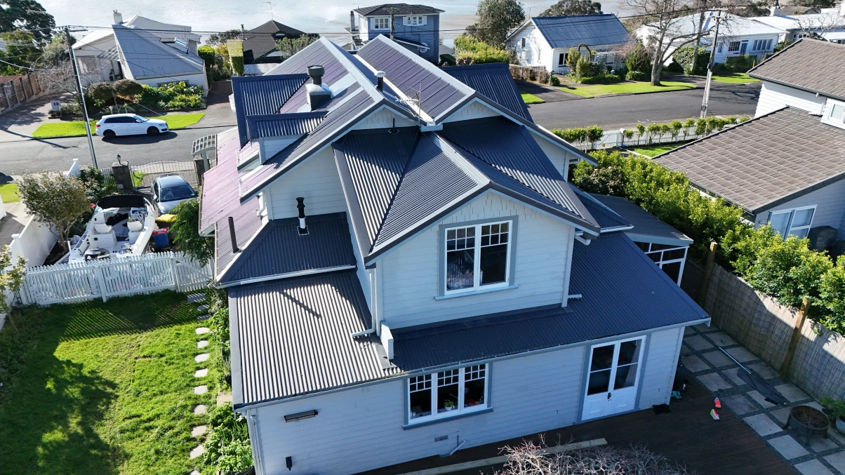 Aerial view of a grey house with a grey friars corrugated metal roof.
